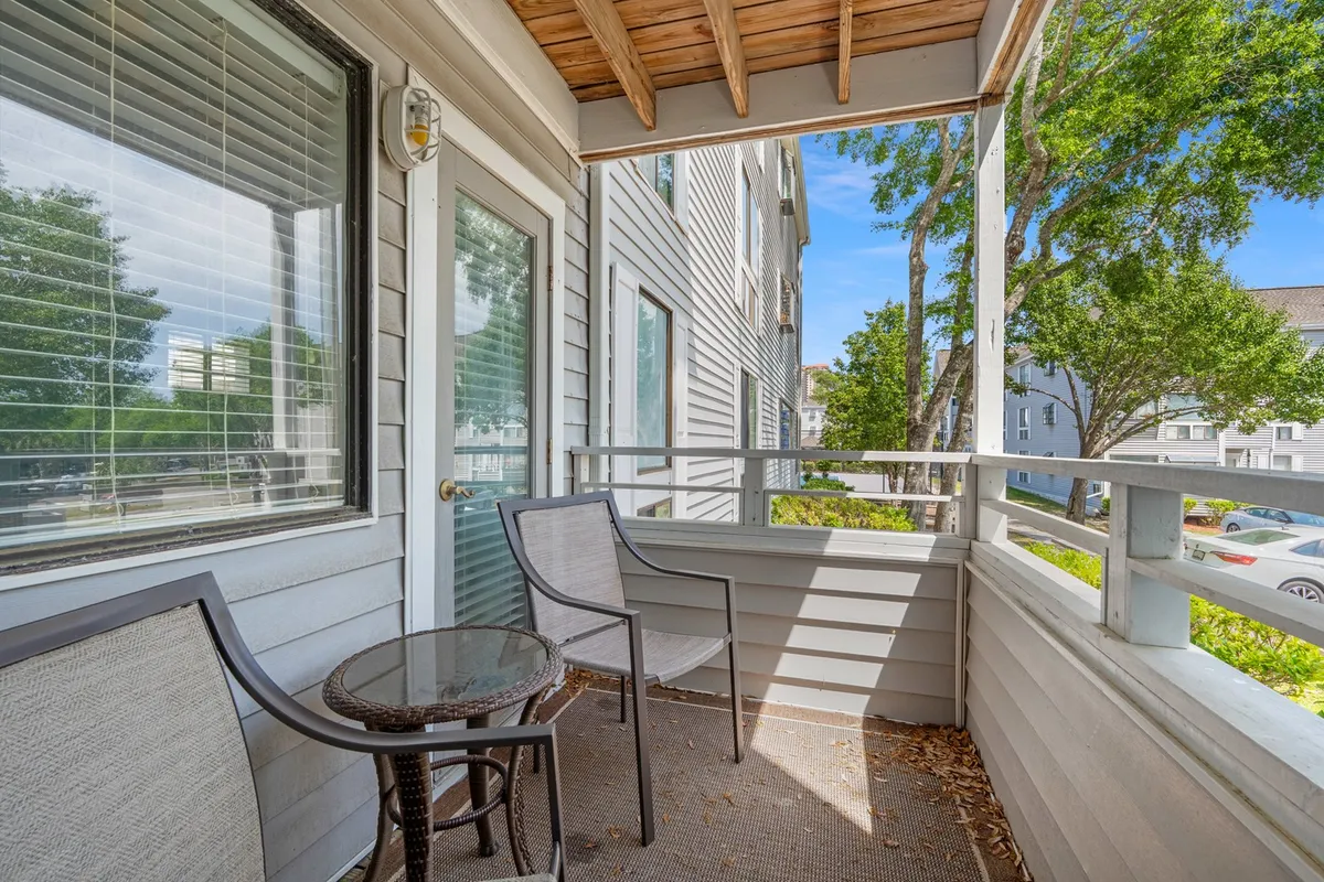 A private balcony set with a small table and chairs, surrounded by lush greenery—an inviting spot where guests can savor morning coffee, unwind, or enjoy the gentle coastal breeze.